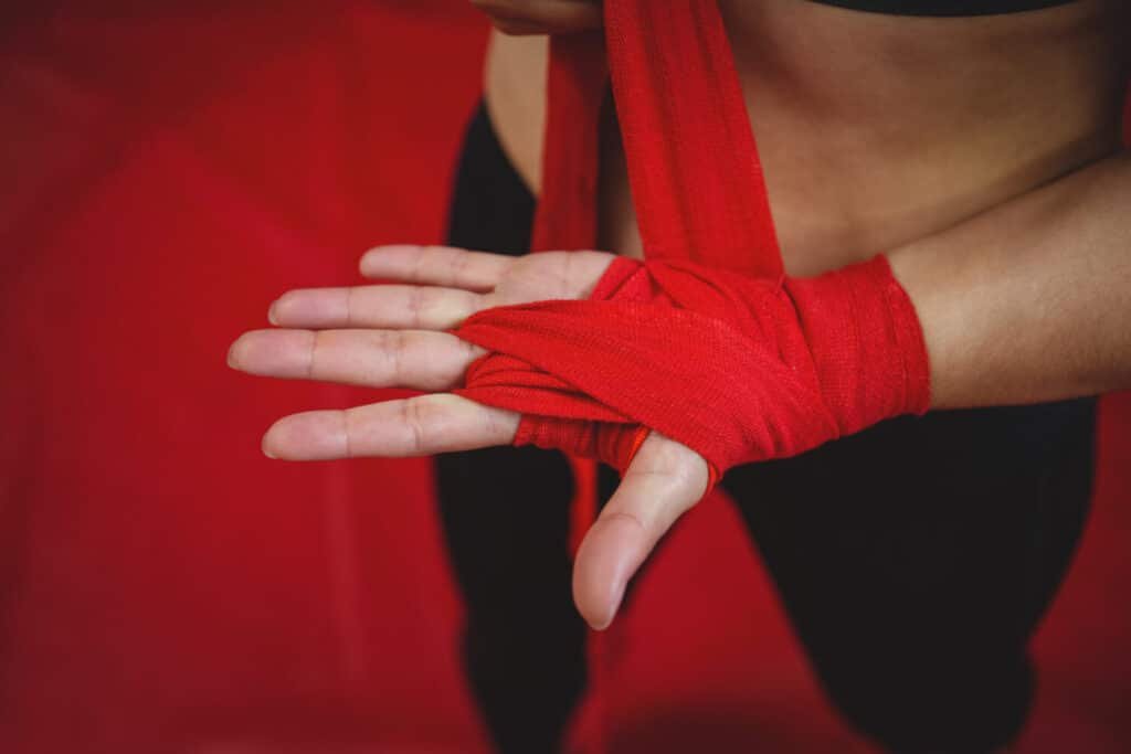 A boxer putting on hand wraps