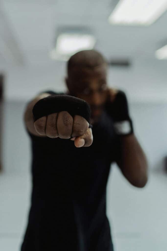 Boxer throwing an improved cross at the camera