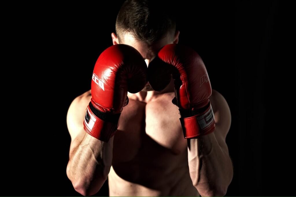 Solo boxer wearing sparring gloves in a guard stance