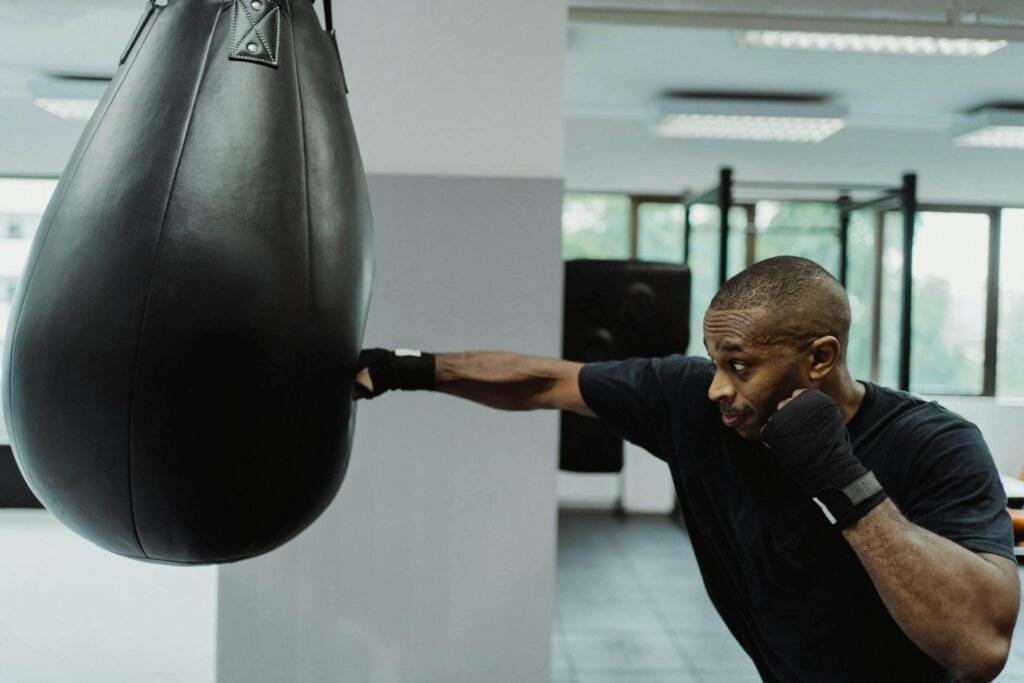 Boxer outlining how to throw a cross on the heavy bag