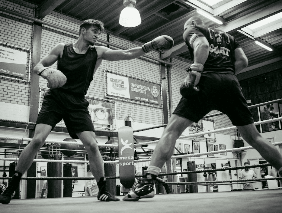 A boxer doing head movement by pulling out of range in sparring