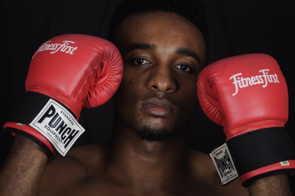 Man holding his boxing gloves up