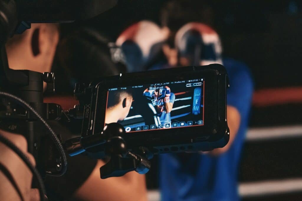 A boxer standing in front of a camera block his head