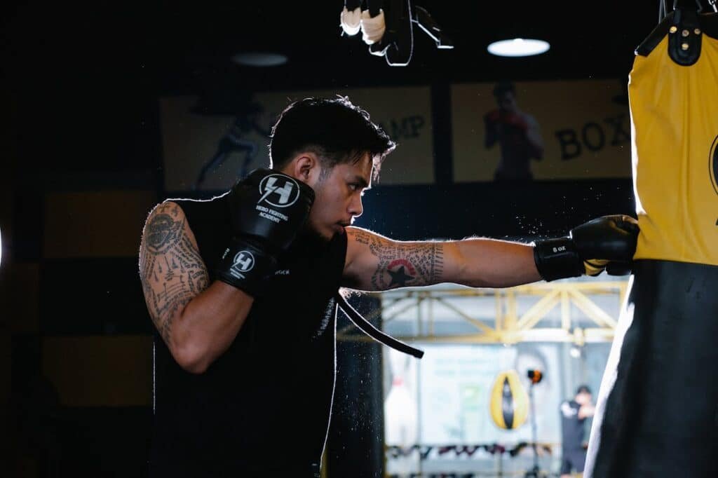 Boxer landing a jab onto the heavy bag