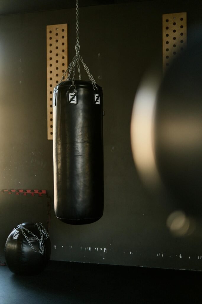 A boxing heavy bag stationary in a boxing gym