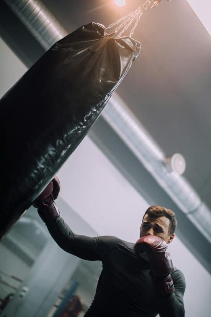 Beginner doing some heavy bag workouts and landing a hook to the body