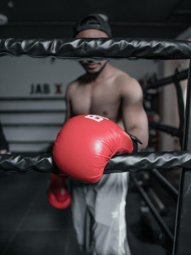 boxer wearing modern ages boxing gloves in a boxing ring