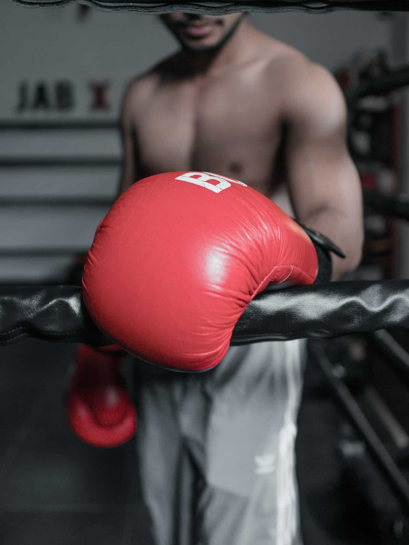 Boxer wearing red boxing gloves in a boxing ring