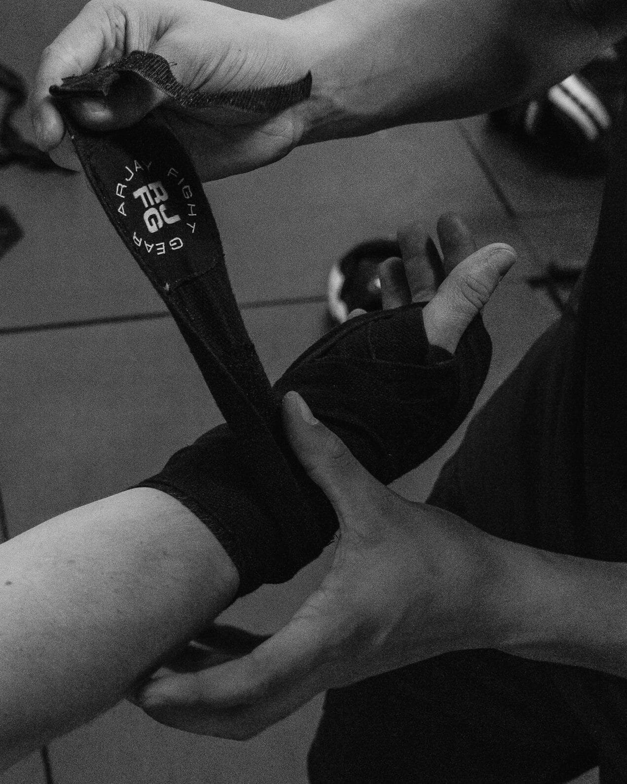 A boxer getting their hands wrapped by a boxing coach