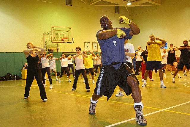 A man leading a boxing exercise class