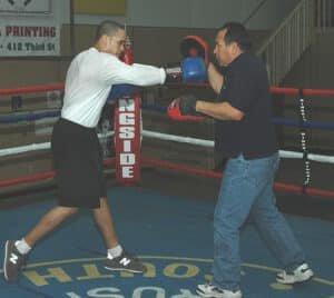 Boxer and coach doing drills with good pads and gloves