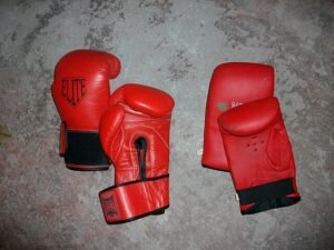 two pairs of boxing gloves laying on the floor
