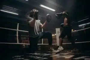 A child learning boxing with small gloves on small hands