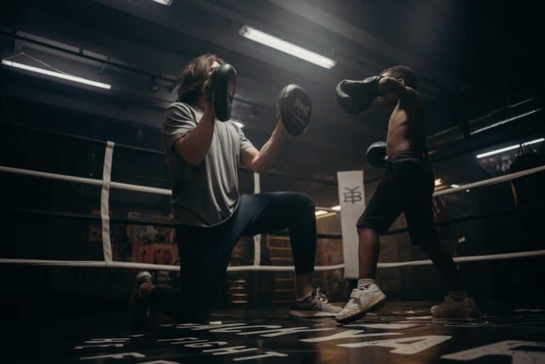 A child learning boxing with small gloves on small hands