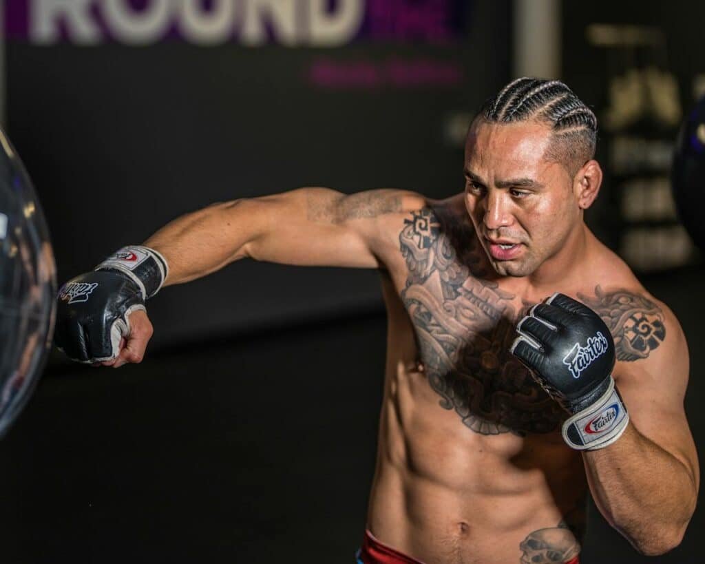MMA fighter doing a heavy bag drill like in boxing