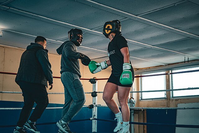 Tow beginner boxers touch gloves as respect to start sparring