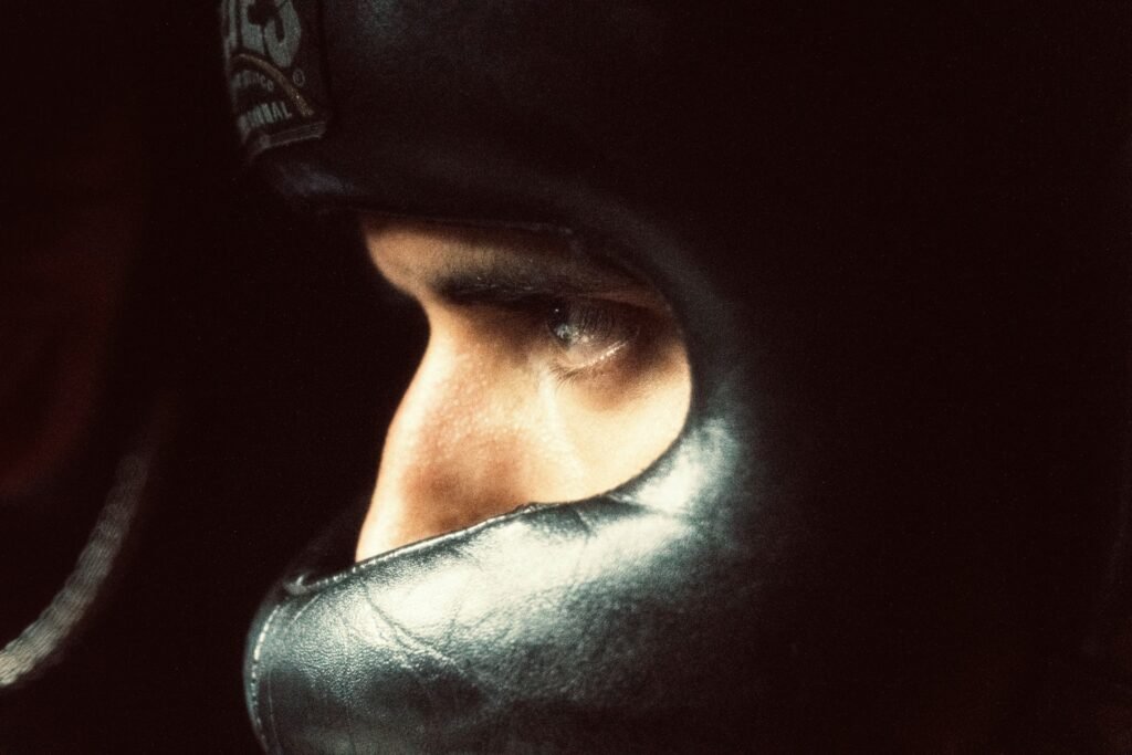 Beginner boxer stares intently wearing a boxing headgear