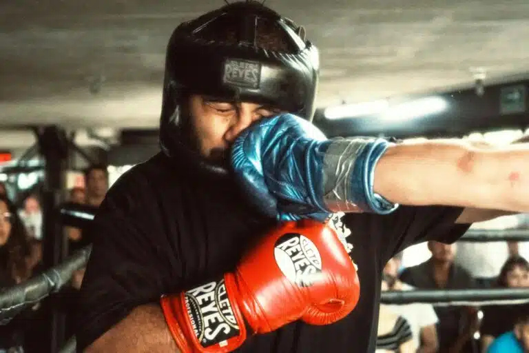 Boxer closing his eyes as he is punched in a boxing fight