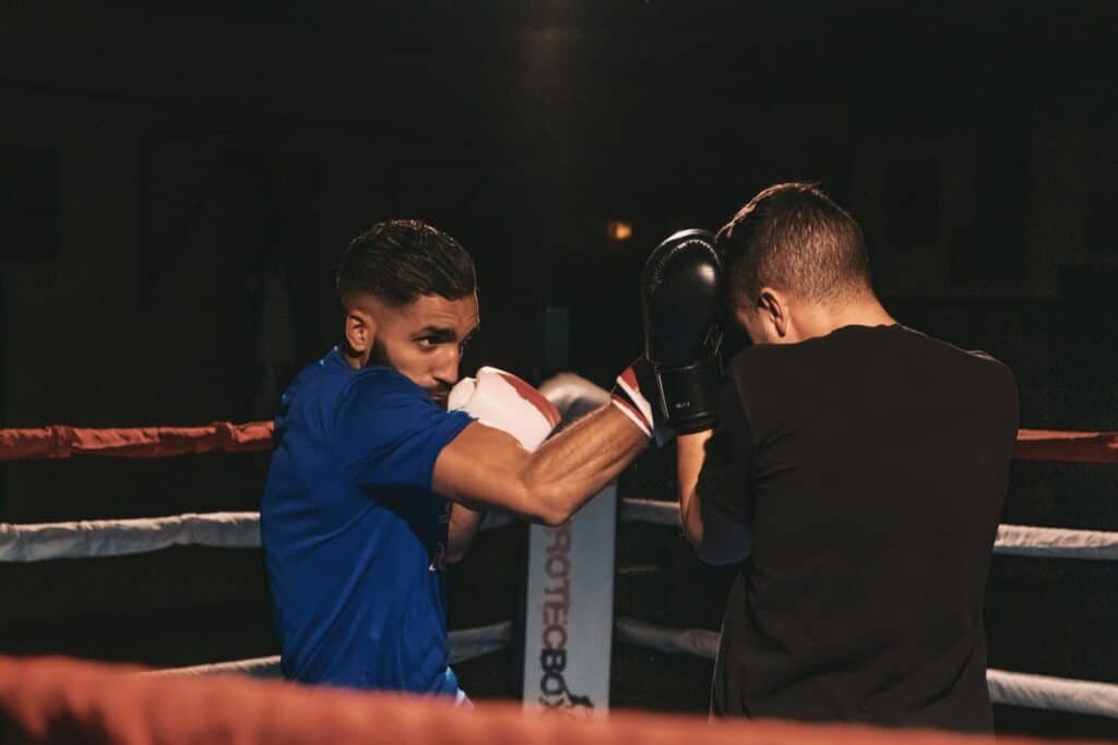 A boxer blocks a punch while sparring