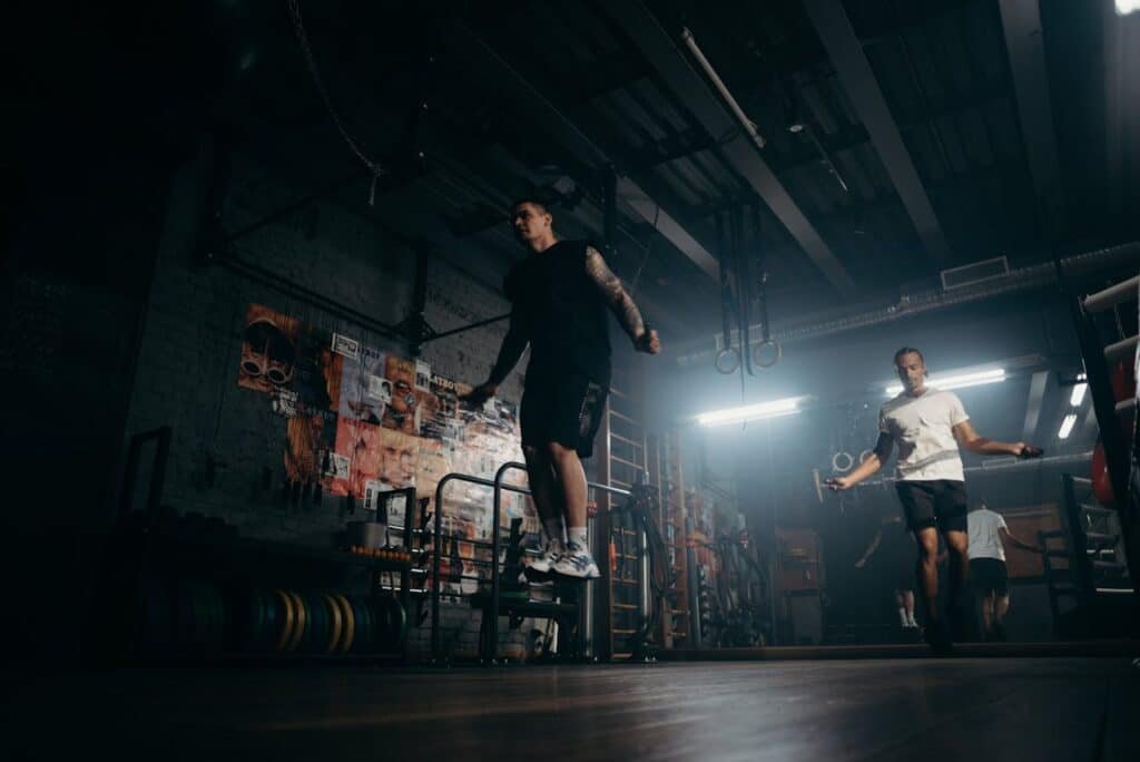 boxer skipping in a dark gym while he is doing a beginner training course