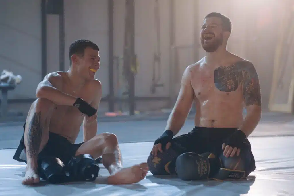 Tow boxers laughing while wearing mouthguard